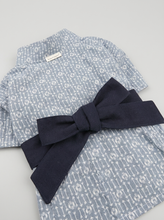 Load image into Gallery viewer, detail — arrow print texture and sash bow

